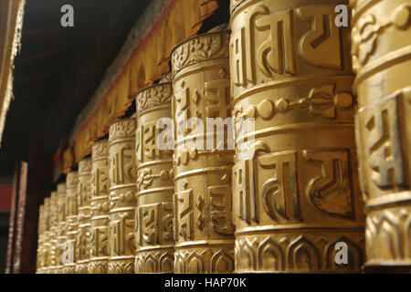 Golden prayer wheels or Mani wheels at Swayambhu Nath temple, Kathmandu, Nepal. Stock Photo