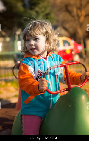 Little girl playing at the playground Stock Photo - Alamy