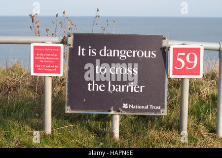 National Trust sign, dangerous cliffs, The Leas, South Shields, South Tyneside, England, UK Stock Photo