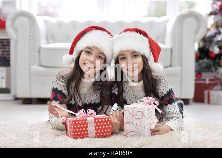 Twin girls with presents Stock Photo