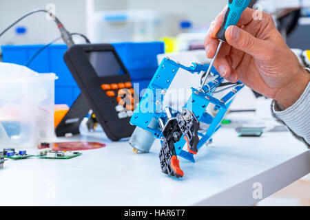 Adjusting an industrial robot with a CNC computer control Stock Photo