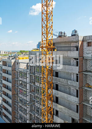 Side of of a house construction high-rise multilevel building with right angles amid crane Stock Photo