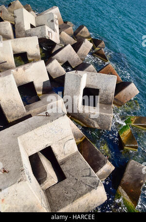 Breakwater blocks in the port. Breakwater of the rectangular stone figures. Stock Photo
