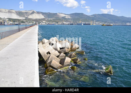 Breakwater blocks in the port. Breakwater of the rectangular stone figures. Stock Photo