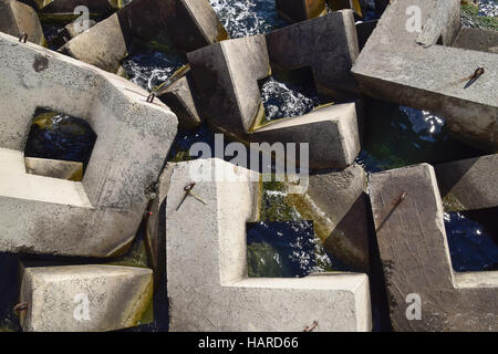 Breakwater blocks in the port. Breakwater of the rectangular stone figures. Stock Photo