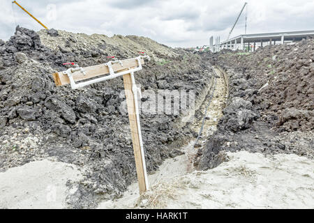 Several faucets with fresh water are placed temporarily at construction site for washing worker's hands. Stock Photo