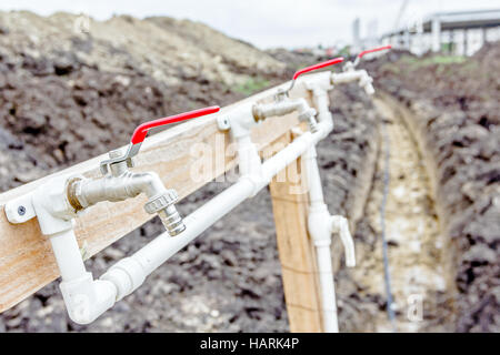 Several faucets with fresh water are placed temporarily at construction site for washing worker's hands. Stock Photo