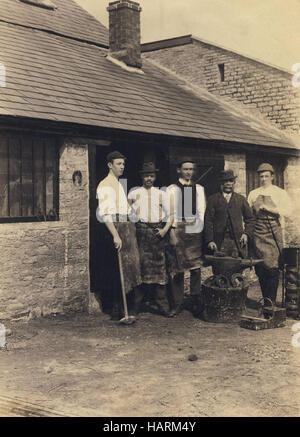 Historic archive image of blacksmith workers outside forge c1910s Stock Photo