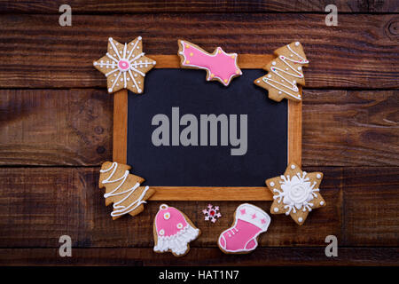 Christmas cookies and vintage black board for text. Holiday background Stock Photo
