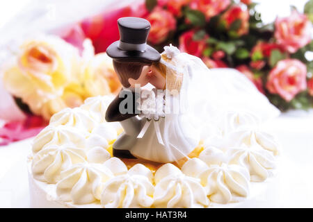 Wedding cake topped with a bride and groom figurine Stock Photo