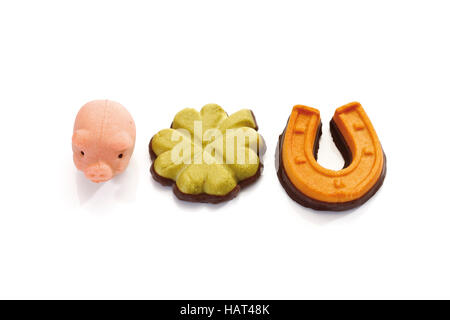 Lucky charms made of marzipan, pig, horseshoe and clover leaf Stock Photo