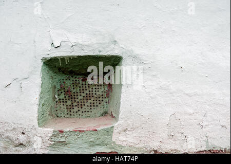Old wall rusty ventilation grate with small holes Stock Photo
