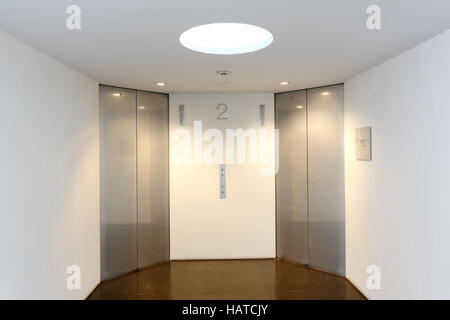 Two modern elevator with closed metal doors Stock Photo