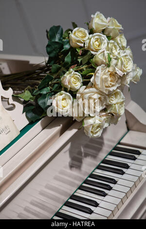 Bouquet of roses on the grand piano Stock Photo