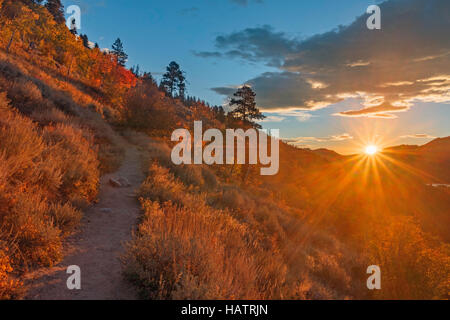 The sun shines brightly on a crisp, fall morning in the mountains. Stock Photo