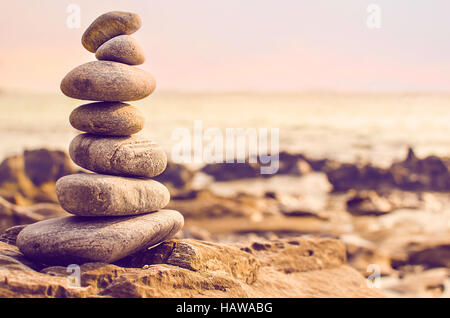 Stones laid out in the form of a pyramid on the seashore Stock Photo