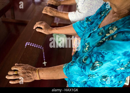 Catholics attend evening prayers at St Peter's Chapel, a small wooden building in Dalat, Mukah Division, Sarawak, Malaysia. Stock Photo