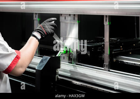 Worker at manufacture workshop operating cidan folding machine Stock Photo