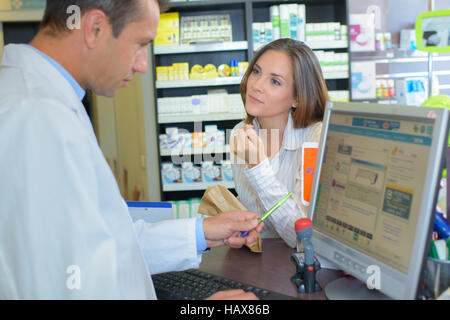 Female customer talking to male pharamacist Stock Photo