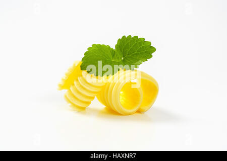 Curls of fresh butter on white background Stock Photo