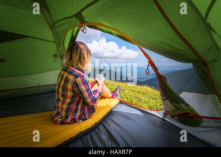 girl with cup in summer mountains Stock Photo