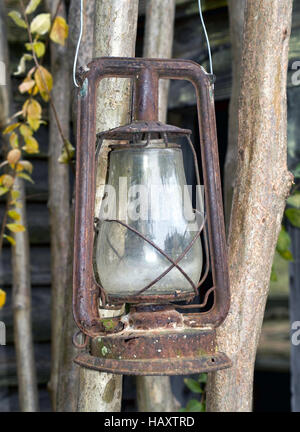 Old rusty gold antique coal oil lantern. Stock Photo