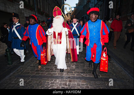 Brussels, Belgium. 03rd Dec, 2016. Saint-Nicholas and his two helpers dressed traditionally as Black Pete characters walk through Brussels on the annual Saint-Nicholas parade. Credit:  Frederik Sadones/Pacific Press/Alamy Live News Stock Photo