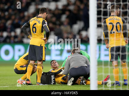 Arsenal's Gabriel Paulista receives treatment for an injury during the Premier League match at the London Stadium. Stock Photo