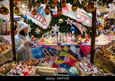 Saleswoman behind the counter at the New Year Fair in central Moscow shop GUM, Russia Stock Photo