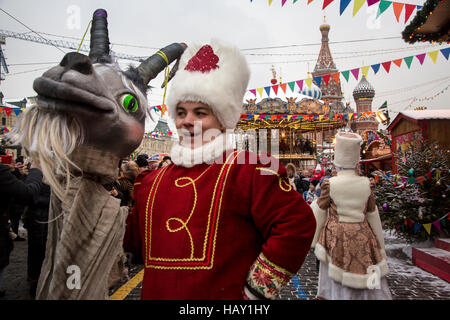 People in national costumes singing carols at the GUM-Fair on the Red Square in Moscow, Russia Stock Photo