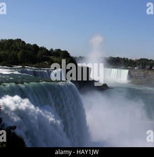 Horseshoe Falls and Bridal Veil Falls at Niagara Falls taken from Niagara Falls State Park on the American side with rising mist Stock Photo