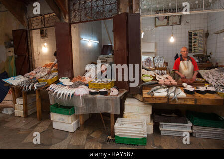 Fisherman stands in a market of Fez, Morocco. Stock Photo