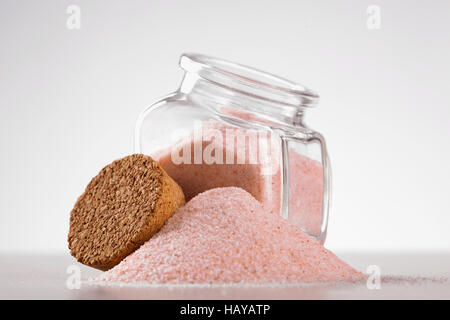 pink Himalayan salt in glass jar on white background Stock Photo