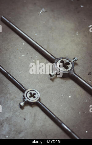 Round pipe thread dies on a concrete background Stock Photo