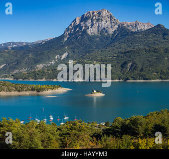 View of the Grand Morgon peak on Summer afternoon. The Saint Michel Bay (with the Chapel) and Serre Poncon Lake. France Stock Photo