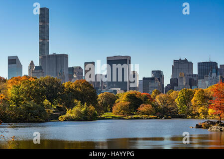 Fall in Central Park at The Lake with Midtown skyscrapers. Morning view with colorful Autumn foliage. Manhattan, New York City Stock Photo