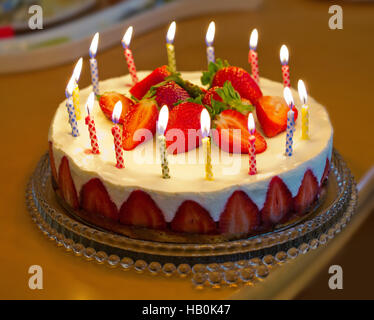 Strawberry birthday cake with candles. Stock Photo