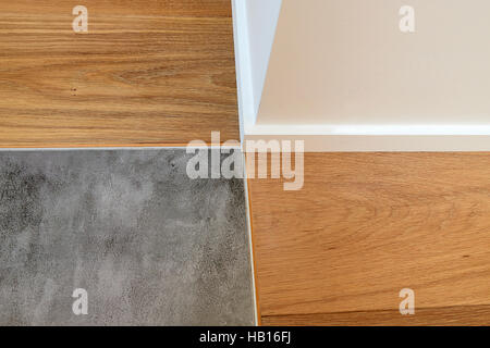 Close up on joints between wood, baseboards and stone floor Stock Photo
