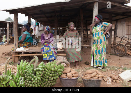 Black African women in ethnic or traditional clothes market stall rural west Africa Stock Photo