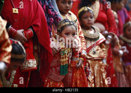 Bhaktapur, Nepal. 4th Dec, 2016. A Nepalese Newar girl stands beside her mother during Bel Bibaha or Ehee rituals in Bhaktapur, Nepal on Sunday, December 4, 2016. Pre adolescent girls from Newar community get married thrice, the first to the Bel or holy fruit, second is the marriage with the Sun and the third a real husband. Performing these rituals to ward evil spirits, but mainly to protect her from widowhood holds the ritual ceremony. Credit:  Skanda Gautam/ZUMA Wire/Alamy Live News Stock Photo