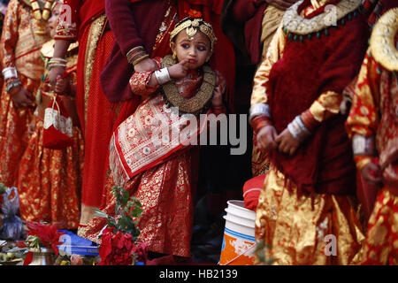 Bhaktapur, Nepal. 4th Dec, 2016. A Nepalese Newar girl stands beside her mother during Bel Bibaha or Ehee rituals in Bhaktapur, Nepal on Sunday, December 4, 2016. Pre adolescent girls from Newar community get married thrice, the first to the Bel or holy fruit, second is the marriage with the Sun and the third a real husband. Performing these rituals to ward evil spirits, but mainly to protect her from widowhood holds the ritual ceremony. Credit:  Skanda Gautam/ZUMA Wire/Alamy Live News Stock Photo