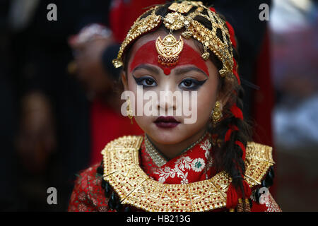 Bhaktapur, Nepal. 4th Dec, 2016. A Nepalese Newar girl looks on during Bel Bibaha or Ehee rituals in Bhaktapur, Nepal on Sunday, December 4, 2016. Pre adolescent girls from Newar community get married thrice, the first to the Bel or holy fruit, second is the marriage with the Sun and the third a real husband. Performing these rituals to ward evil spirits, but mainly to protect her from widowhood holds the ritual ceremony. Credit:  Skanda Gautam/ZUMA Wire/Alamy Live News Stock Photo