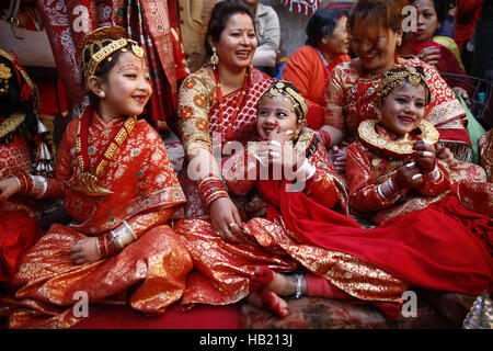 Bhaktapur, Nepal. 4th Dec, 2016. Nepalese Newar girls react before prayers during Bel Bibaha or Ehee rituals in Bhaktapur, Nepal on Sunday, December 4, 2016. Pre adolescent girls from Newar community get married thrice, the first to the Bel or holy fruit, second is the marriage with the Sun and the third a real husband. Performing these rituals to ward evil spirits, but mainly to protect her from widowhood holds the ritual ceremony. Credit:  Skanda Gautam/ZUMA Wire/Alamy Live News Stock Photo