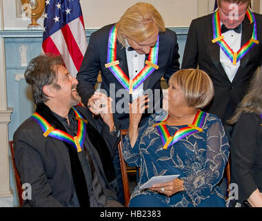 Al Pacino, left, one of the five recipients of the 39th Annual Kennedy Center Honors, gospel and blues singer Mavis Staples, right, and Joe Walsh of the rock band 'The Eagles,' center, congratulate one another as they prepare to pose for a group photo following a dinner hosted by United States Secretary of State John F. Kerry in their honor at the U.S. Department of State in Washington, DC on Saturday, December 3, 2016. The 2016 honorees are: Argentine pianist Martha Argerich; rock band the Eagles; screen and stage actor Al Pacino; gospel and blues singer Mavis Staples; and musician James Ta Stock Photo