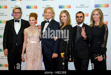 Joe Walsh of the rock band 'The Eagles' and his wife, Marjorie, arrive for the formal Artist's Dinner honoring the recipients of the 39th Annual Kennedy Center Honors hosted by United States Secretary of State John F. Kerry at the U.S. Department of State in Washington, DC on Saturday, December 3, 2016. The 2016 honorees are: Argentine pianist Martha Argerich; rock band the Eagles; screen and stage actor Al Pacino; gospel and blues singer Mavis Staples; and musician James Taylor. From left to right: Christian Quilici, unidentified, Joe Walsh, Marjorie Walsh, Ringo Starr, and Barbara Bach. Cr Stock Photo