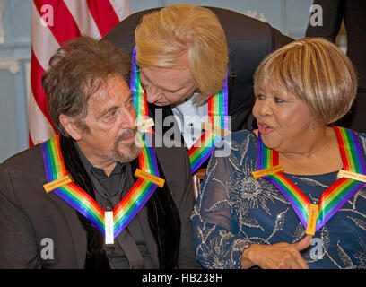 Al Pacino, left, one of the five recipients of the 39th Annual Kennedy Center Honors, gospel and blues singer Mavis Staples, right, and Joe Walsh of the rock band 'The Eagles,' center, share some words as they prepare to pose for a group photo following a dinner hosted by United States Secretary of State John F. Kerry in their honor at the U.S. Department of State in Washington, DC on Saturday, December 3, 2016. The 2016 honorees are: Argentine pianist Martha Argerich; rock band the Eagles; screen and stage actor Al Pacino; gospel and blues singer Mavis Staples; and musician James Taylor. Cr Stock Photo