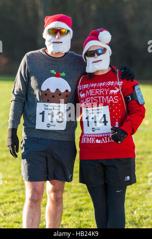 London, UK.  4 December 2016.  Runners in festive costumes take part in the Santa Dash in Cassiobury Park in Watford, raising funds for Mencap, a charity supporting people with a learning disability and their families.  This event is one of many Santa-inspired races taking place today across London raising funds for good causes. Credit:  Stephen Chung / Alamy Live News Stock Photo