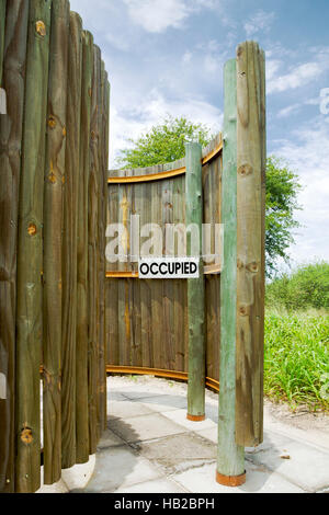 Occupied sign in outdoor toilet in the Central Kalahari Game Reserve in Botswana Stock Photo