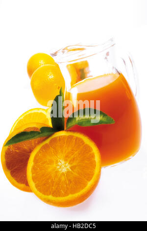 Jug of orange juice with fresh oranges Stock Photo