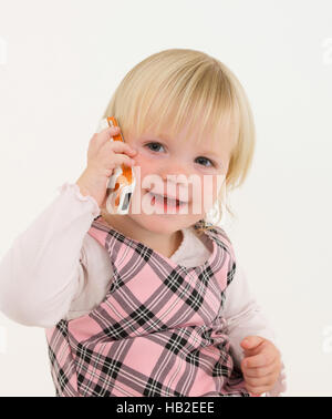Little girl phoning on a mobile phone Stock Photo